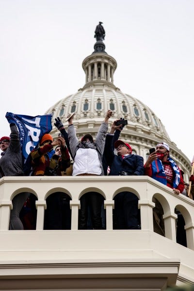 WASHINGTON, DC - JANUARY 06: Pro-Trump supporters storm the US Capitol following a rally with President Donald Trump on January 6, 2021 in Washington, DC. Trump supporters gathered in the nation's capital today to protest the ratification of President-elect Joe Biden's Electoral College victory over President Trump in the 2020 election. (Photo by Samuel Corum/Getty Images) WASHINGTON, DC - JANUARY 06: Pro-Trump supporters storm the US Capitol following a rally with President Donald Trump on January 6, 2021 in Washington, DC. Trump supporters gathered in the nation's capital today to protest the ratification of President-elect Joe Biden's Electoral College victory over President Trump in the 2020 election. (Photo by Samuel Corum/Getty Images)