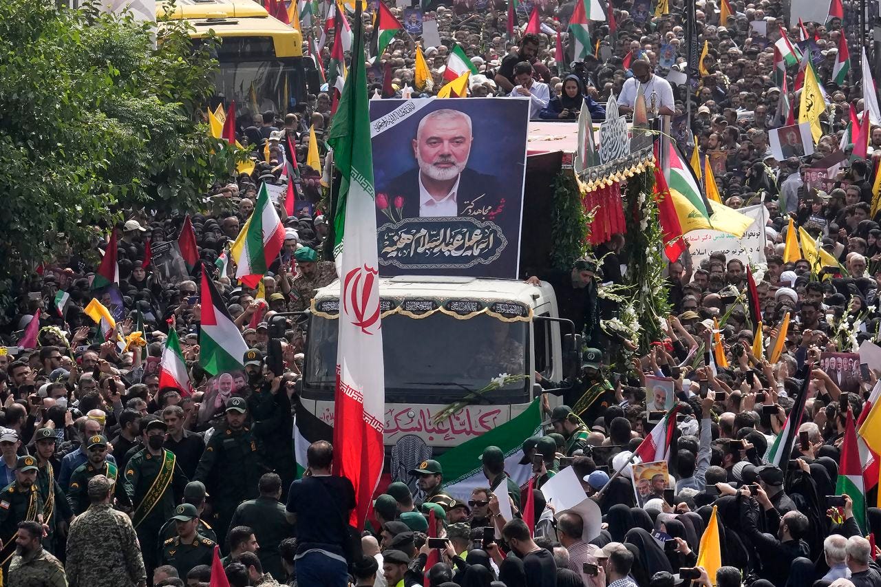 Iranians follow a truck carrying the coffins of Hamas leader Ismail Haniyeh and his bodyguard who were killed in an assassination blamed on Israel during their funeral ceremony in Tehran, Iran, on August 1.