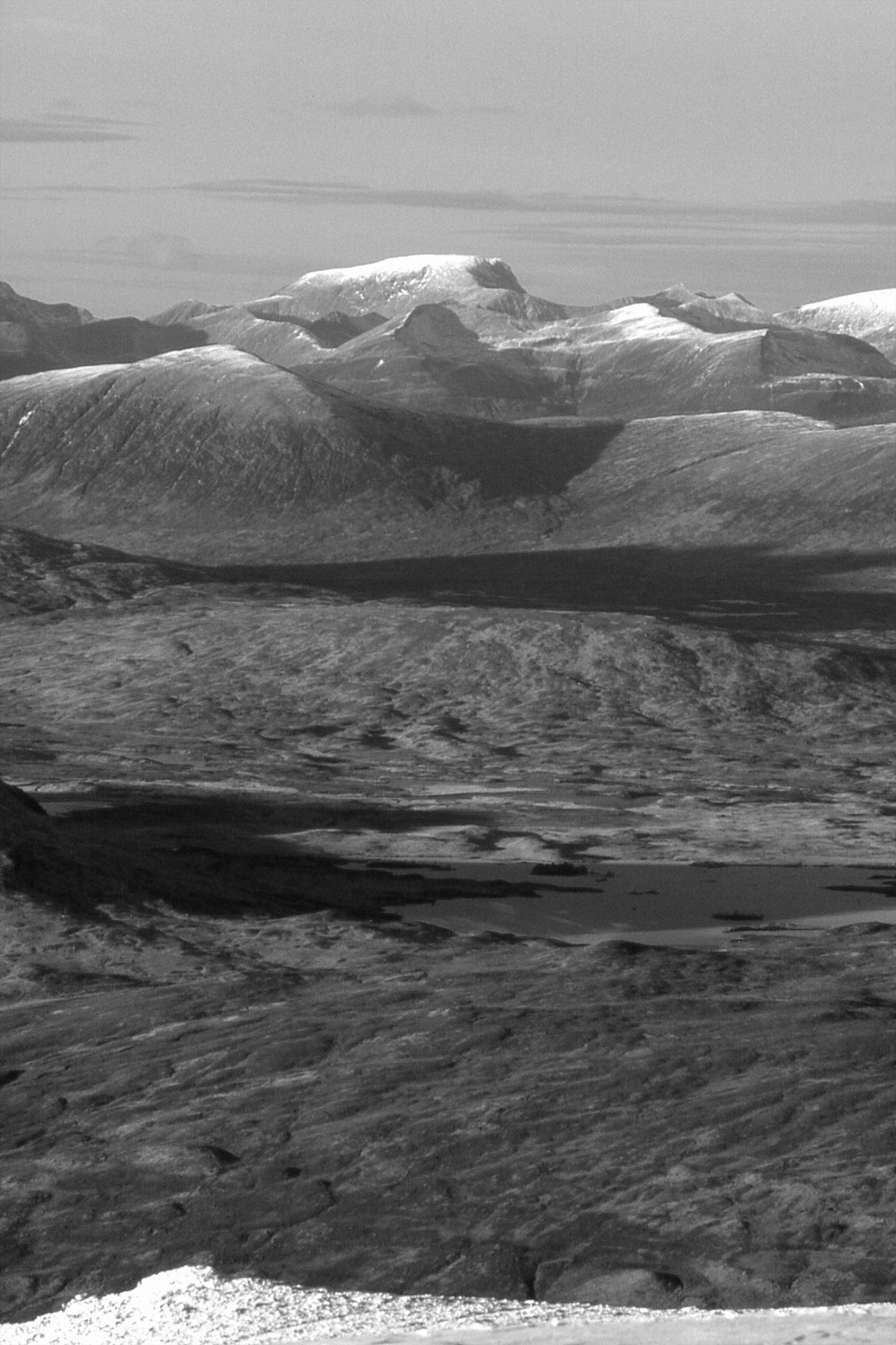 wide moorland, snow-topped mountains beyond
