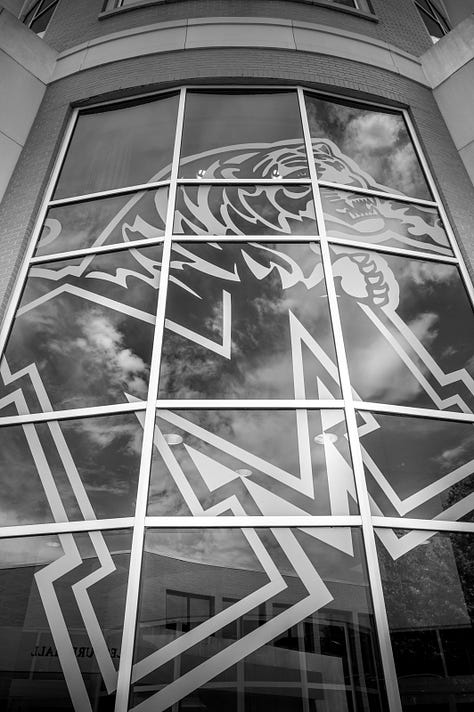 scenes from around campus including a classroom with calculations on whiteboard, ceiling images of cables to power makers space, University of Memphis logo on a chair and window, buildings