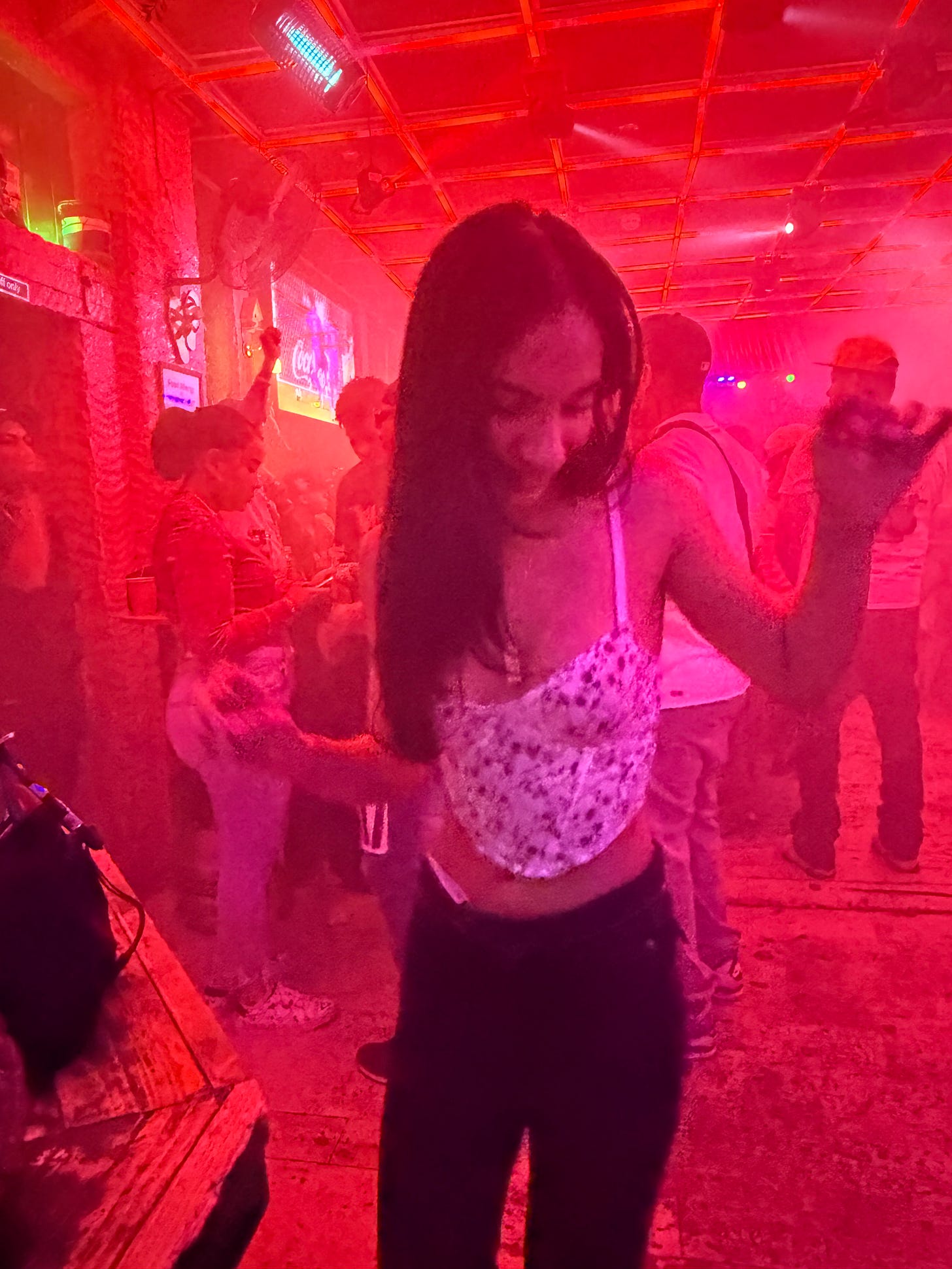 A girl dancing in a red-light club A girl dancing in a red-light club