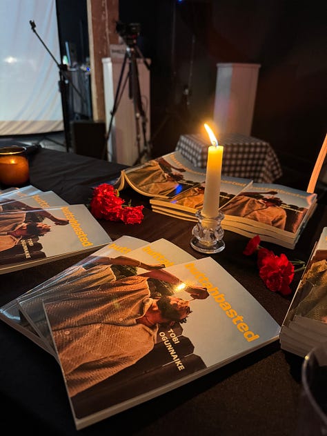 pictures of author signing book at book launch event, and aesthic placement of candles, dim light, and books displayed in accordion style