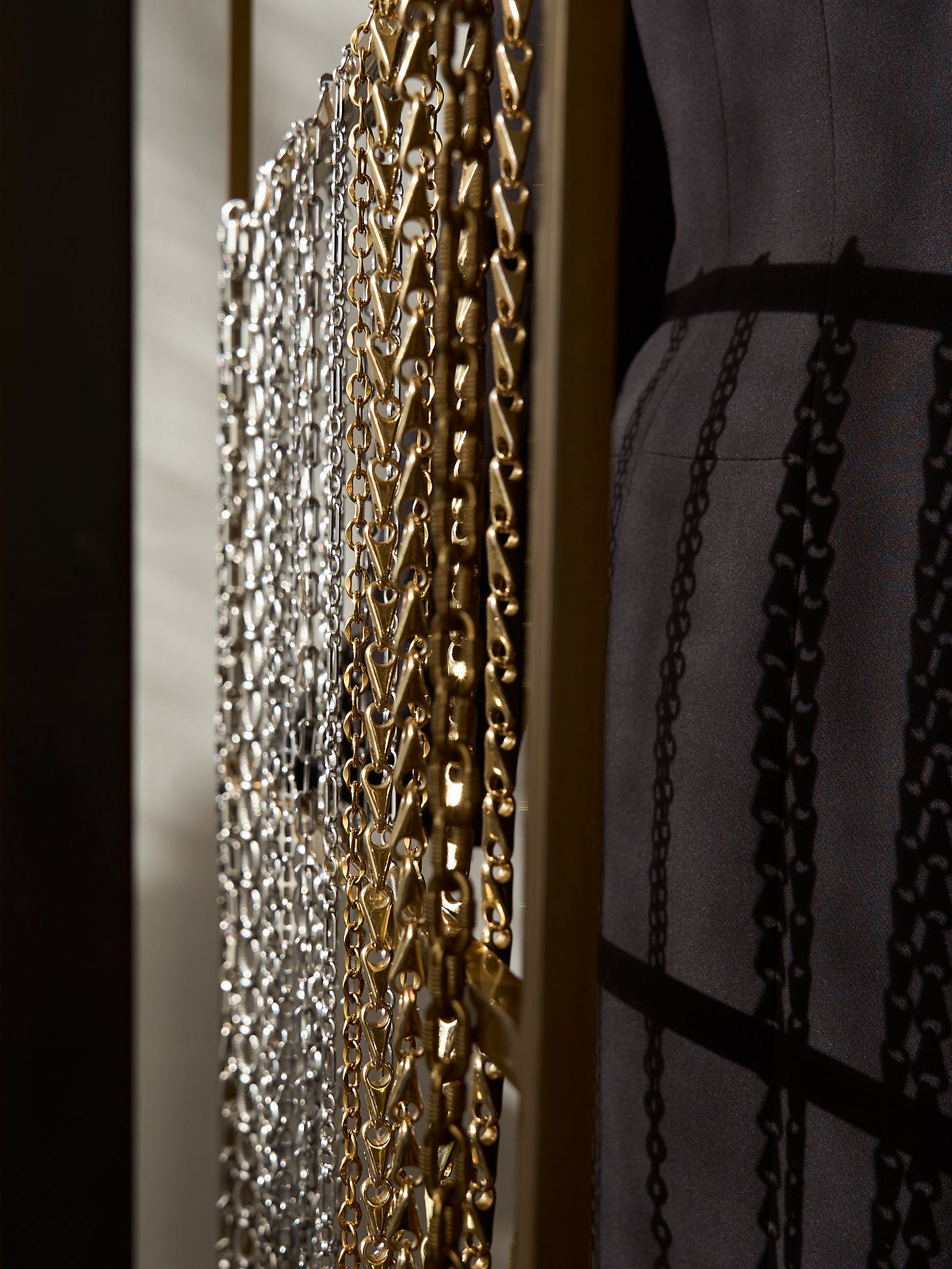 Lapo Lounge Eris, Hyperion, Himalia, and Zira industrial link mixed-metal chain belts hanging from a clothing rack.
