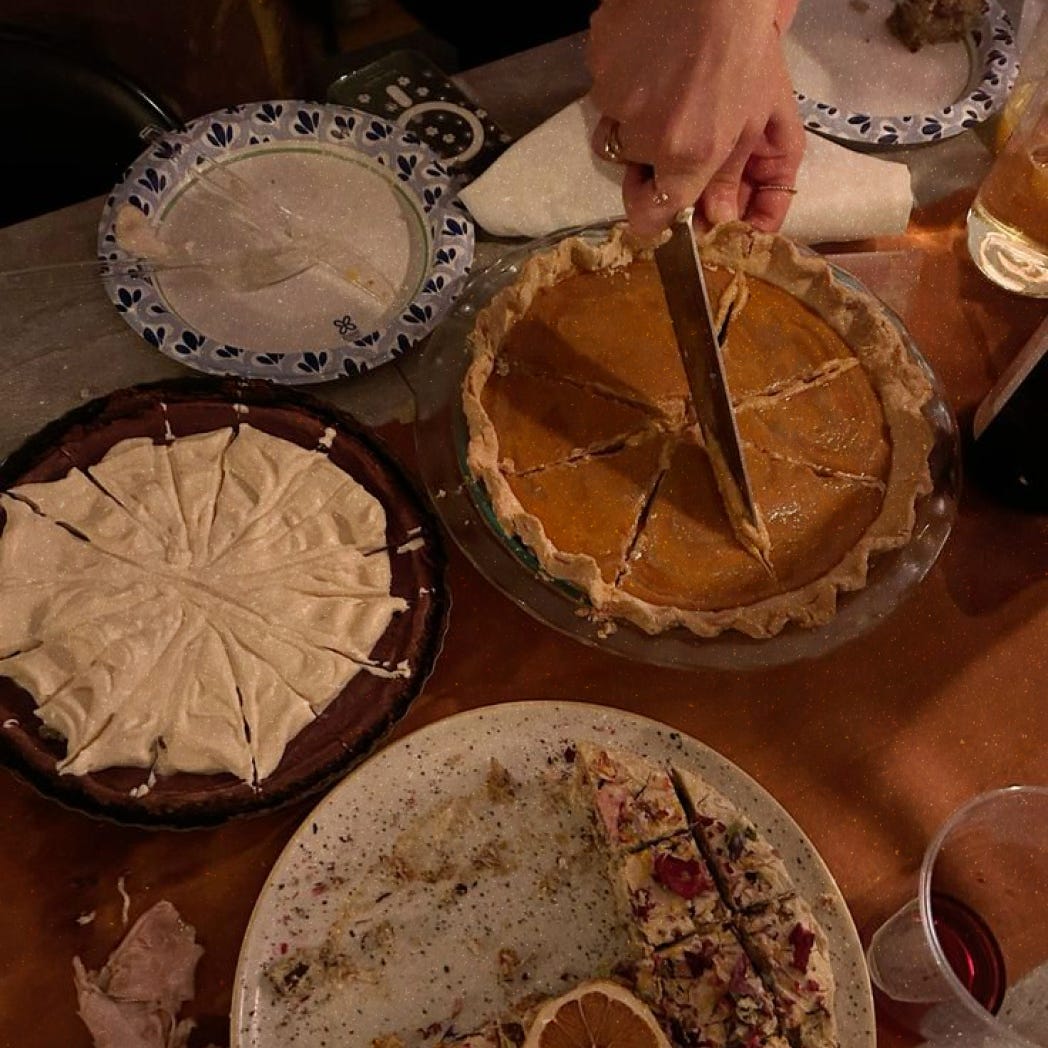 An overhead photo of different pies being sliced