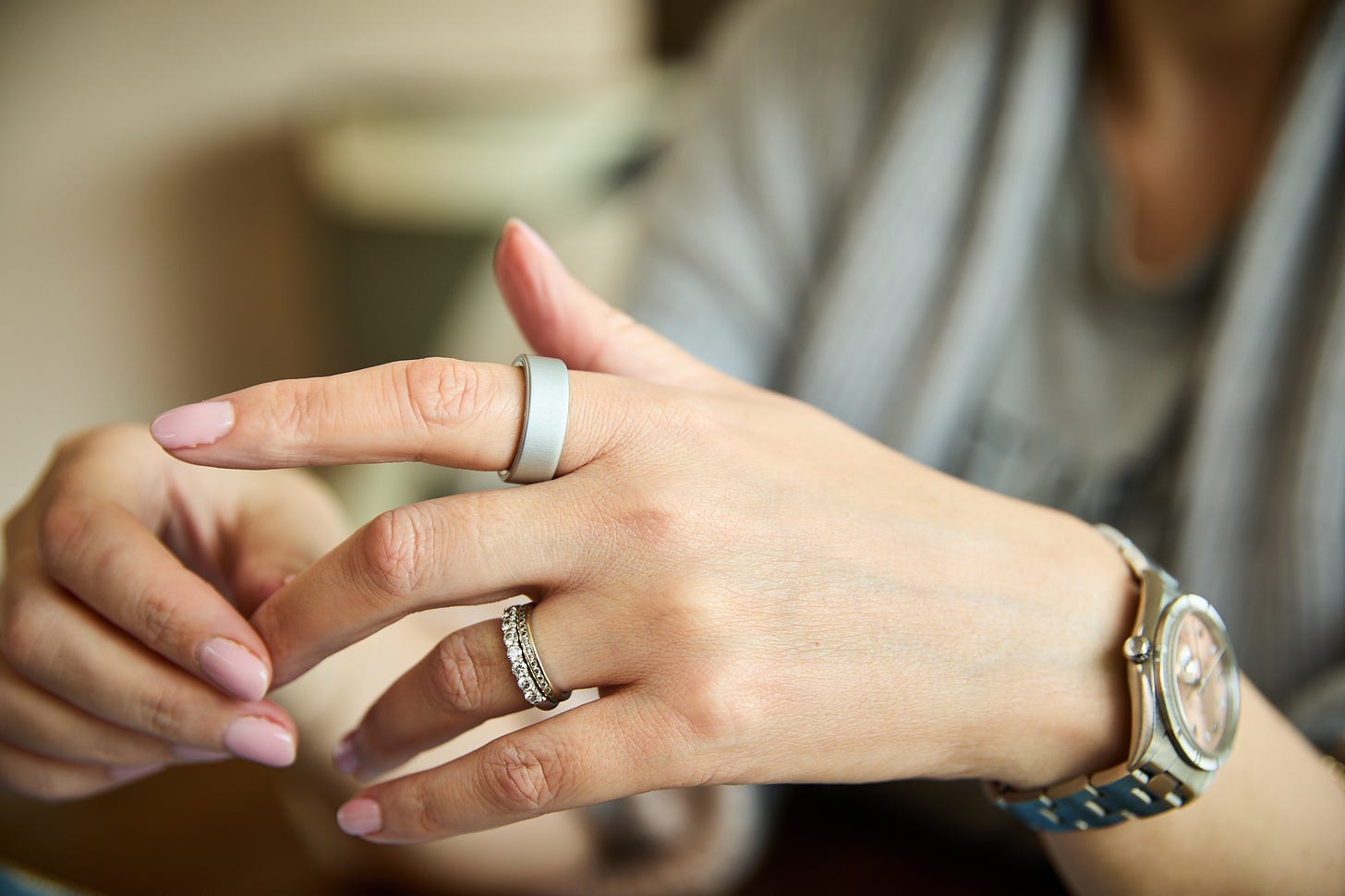 Hands with jewellery including Oura Ring 4 in Brushed Silver