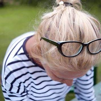 https://thumbs.dreamstime.com/b/closeup-woman-looking-down-glasses-top-her-head-glasses-head-123651680.jpg