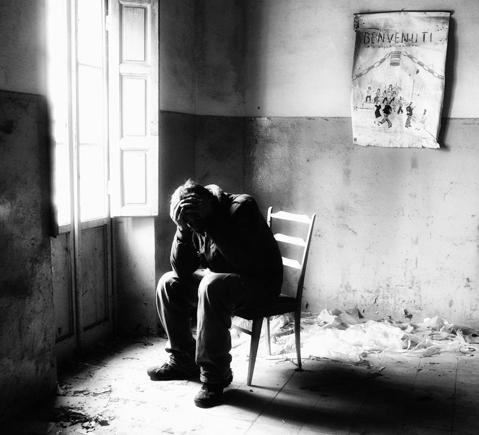 a man sitting in a chair in a room a man sitting in a chair in a room