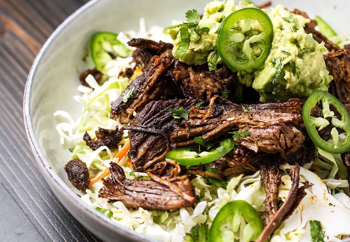 Bowl of Beef Carnitas with Spicy Jalapeño Slaw and Guacamole Bowl of Beef Carnitas with Spicy Jalapeño Slaw and Guacamole