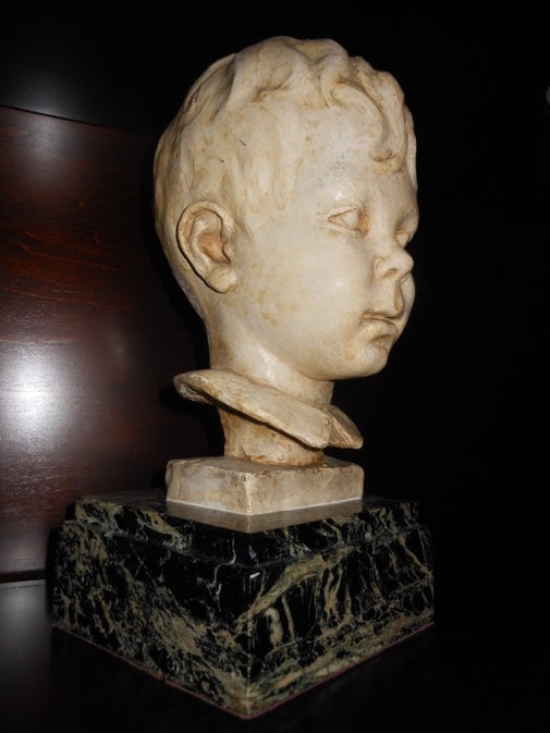 A marble bust of a child

AI-generated content may be incorrect.