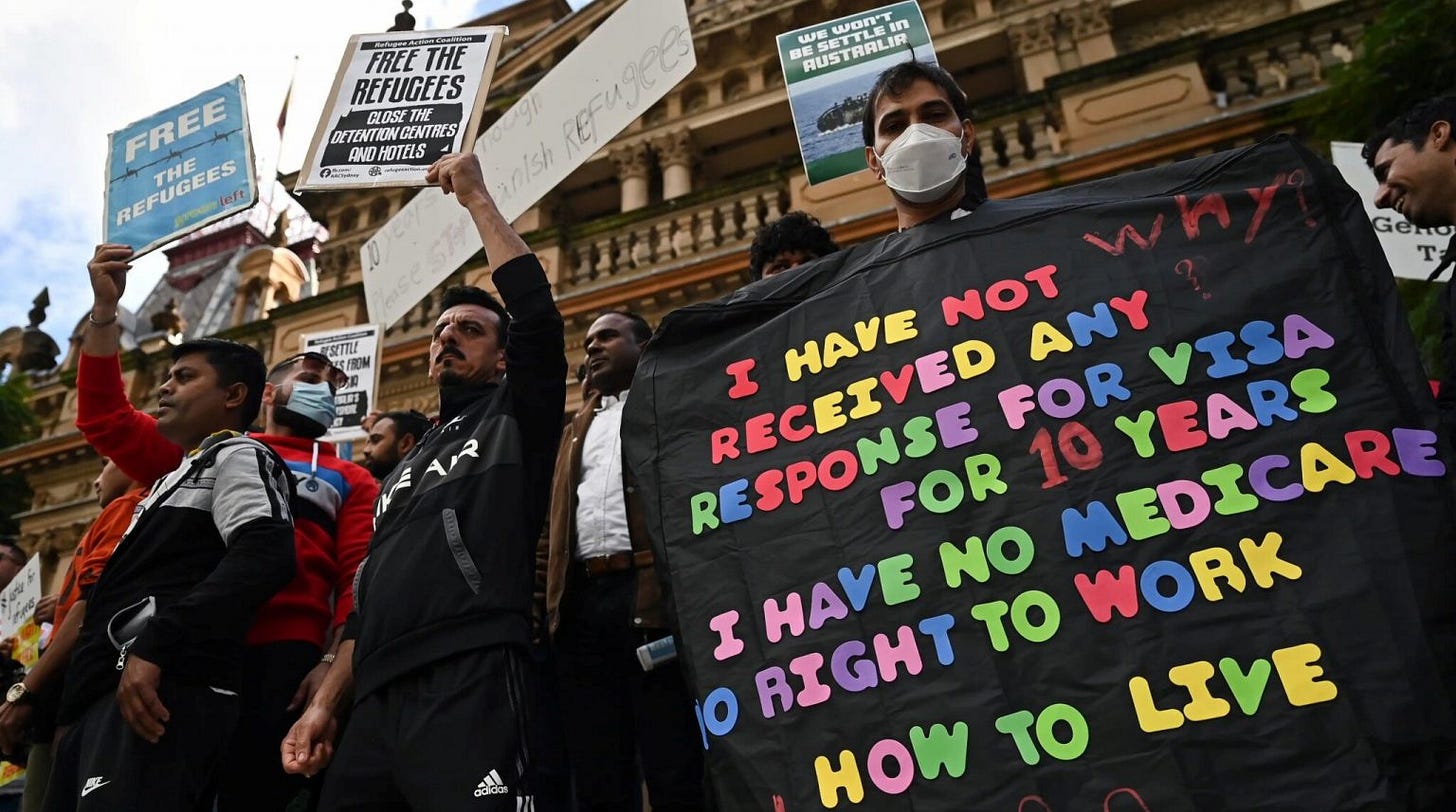 A group of people holding signs

Description automatically generated with medium confidence