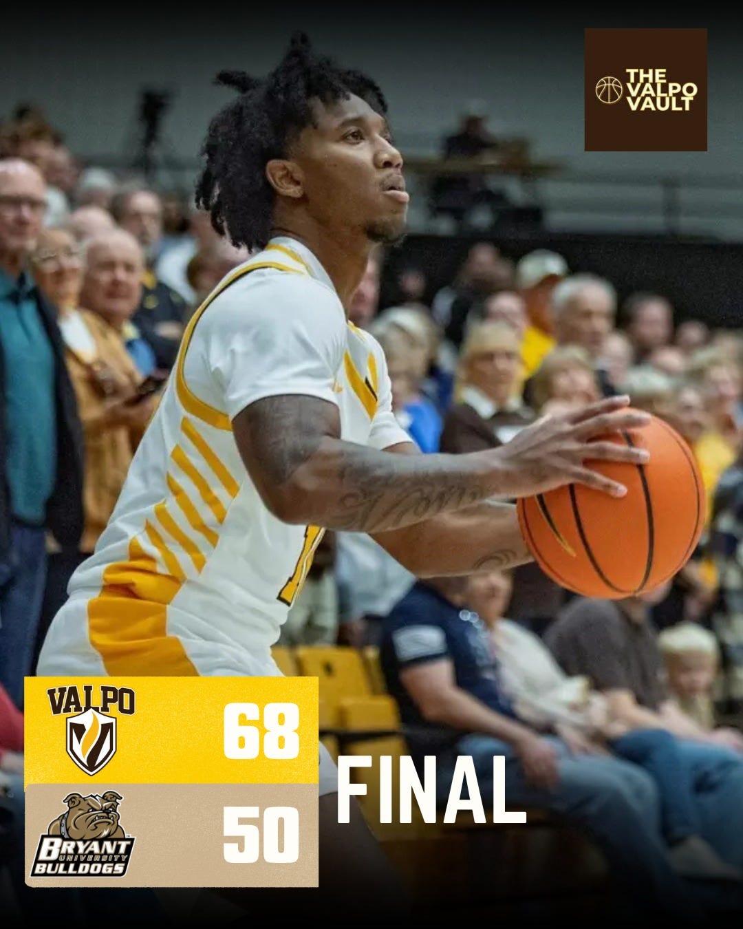 Basketball player with dreadlocks and tattoos dribbles orange basketball on court wearing white jersey with yellow stripes and number 0. Crowd of spectators in background including older fans. Lower section shows yellow graphic with Valpo logo score 68 final against Bryant 50 with bulldog logo.