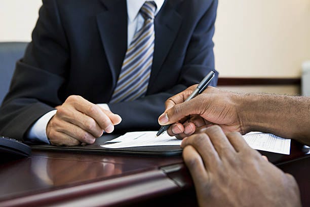 Customer signing paperwork with bank manager  bank financing stock pictures, royalty-free photos & images