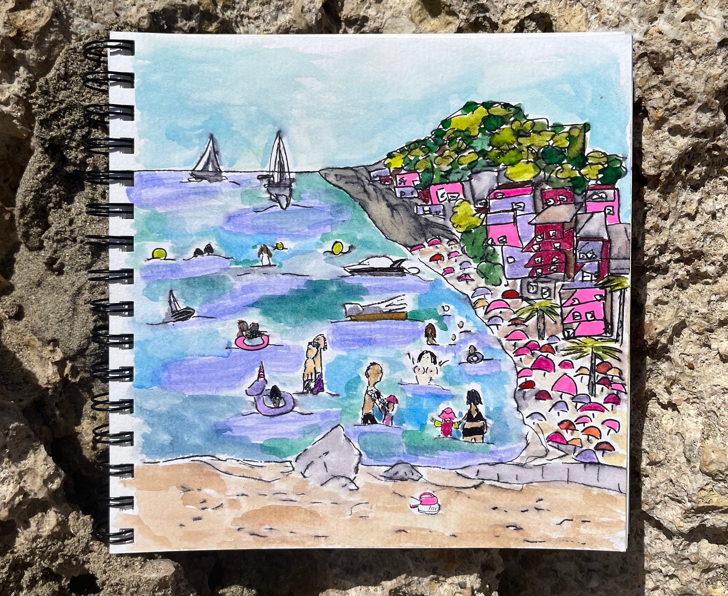 A beach scene made with pen, markers, and watercolors. Blue and purple ocean, light blue and seafoam sky, tan sand, gray rocks and cliffs, green trees, and purple, pink, and maroon houses and umbrellas. In the ocean are various characters - a girl in a purple unicorn floating device, a tattooed father with a daughter in pink hat and long sleeved shirt, a couple standing together looking at the waves, a topless woman with her arms raised, boats, and more. A beach scene made with pen, markers, and watercolors. Blue and purple ocean, light blue and seafoam sky, tan sand, gray rocks and cliffs, green trees, and purple, pink, and maroon houses and umbrellas. In the ocean are various characters - a girl in a purple unicorn floating device, a tattooed father with a daughter in pink hat and long sleeved shirt, a couple standing together looking at the waves, a topless woman with her arms raised, boats, and more.