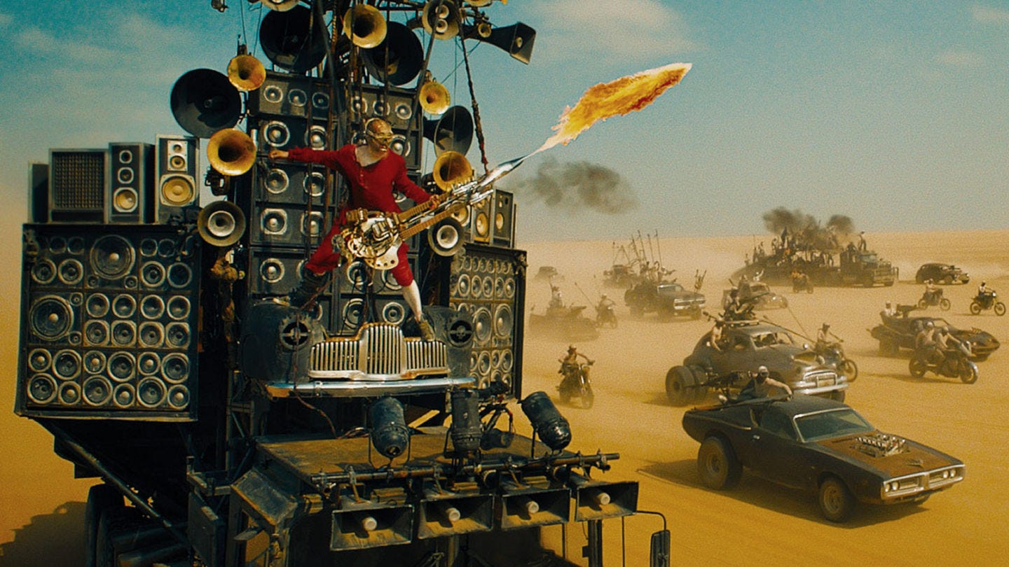 https://prominentmonkey.files.wordpress.com/2015/06/the_doof_warrior_mad_max_fury_road.jpeg