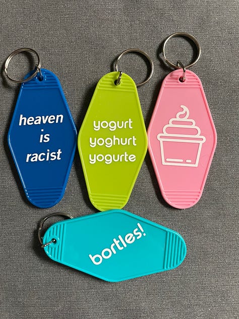 first image is of a little red mushroom drawing on a log. Green and blue is in the background and in black text it says: I'm just a silly little guy who wants to defeat fascism. Second image is four plastic keychains (blue, green, pink, and light blue). They have white text/images on them. One says heaven is racist one says yogurt yoghurt yogurte one is an image of frozen yogurt and one says bortles! these are all related in some way to the show The Good Place. Third image is of a white hand with light green nail polish holding up a tiny box of instant mashed potatoes made out of carstock. Fourth image is of a terrible looking zine with a quote from the Psychology of Fascism , the fourth is a picture of juicy red and orange tomatoes sprinkled with salt and pepper on a piece of white bread with mayo. The last one is a homemade button with a cartoon old man with a big bushy white mustach and glasses. The text is hard to see but it says John Avery Whitaker is a Christofasct (Mr. Whitaker is a beloved character in Focus on the Family's radio drama show Adventures in Odyssey.