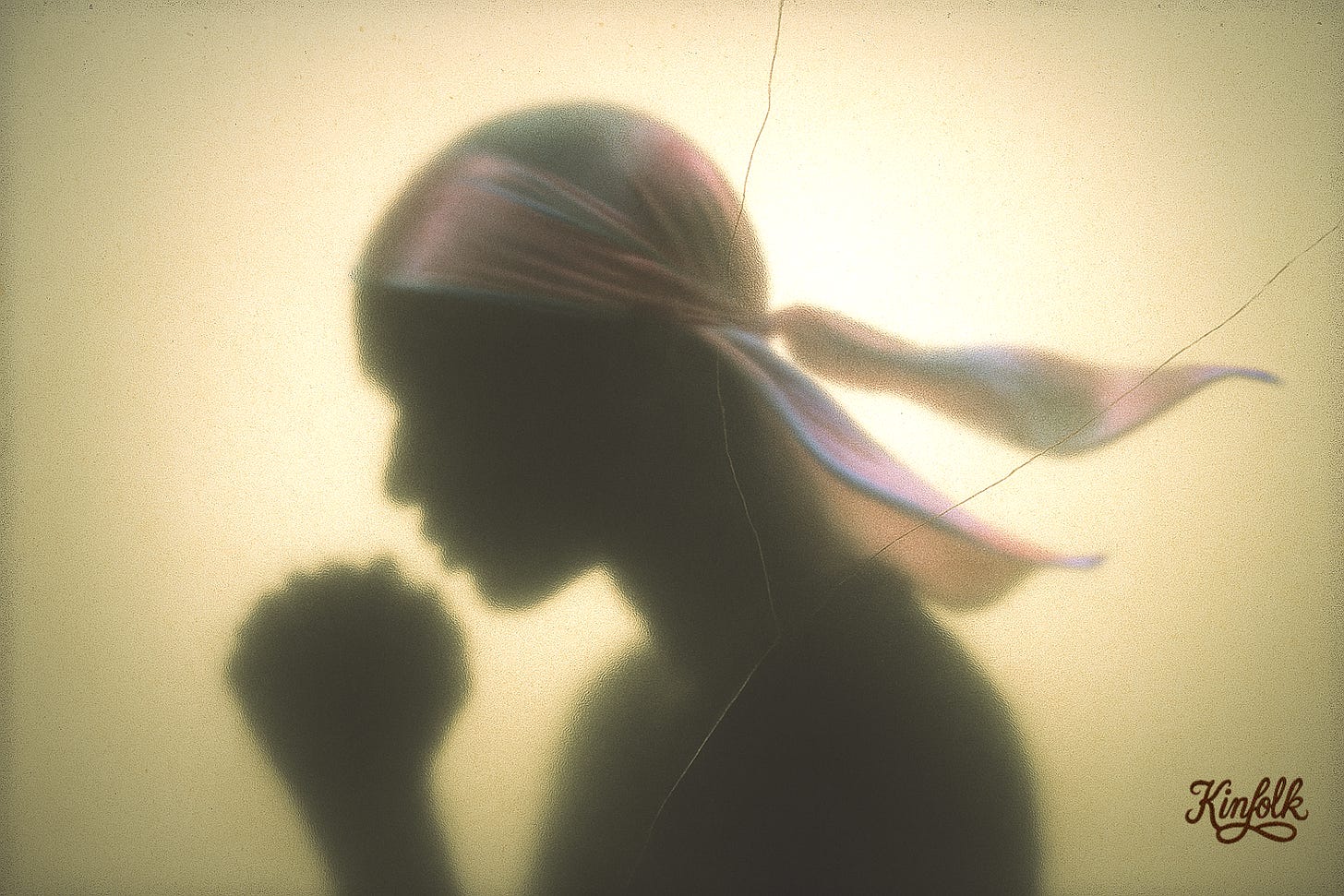 A soft side profile of a person wearing a pastel silk durag, viewed through frosted, amber-tinted glass. The silhouette faces right. The durag’s sheer tails float gently behind. The image is grainy, with scratches and dust specs, giving it the feel of aged film. No facial features—just form, stillness, and presence. A soft side profile of a person wearing a pastel silk durag, viewed through frosted, amber-tinted glass. The silhouette faces right. The durag’s sheer tails float gently behind. The image is grainy, with scratches and dust specs, giving it the feel of aged film. No facial features—just form, stillness, and presence.