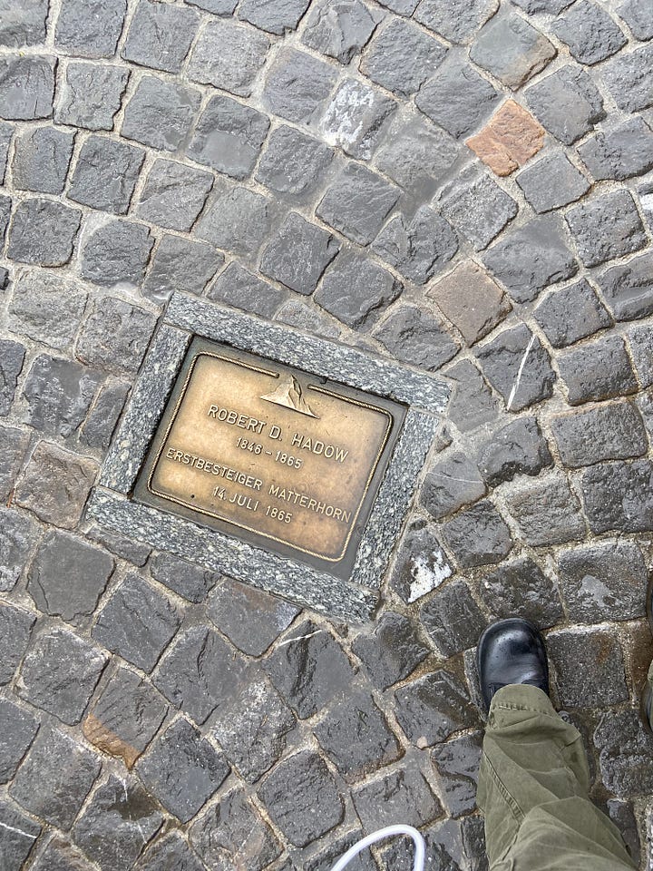 One of the plaques in the Walk of Climb, the Ibex fountain and the Matterhorn Museum, the Marmot fountain, and the Bronze Alphorn, which is pointed directly at the Matterhorn