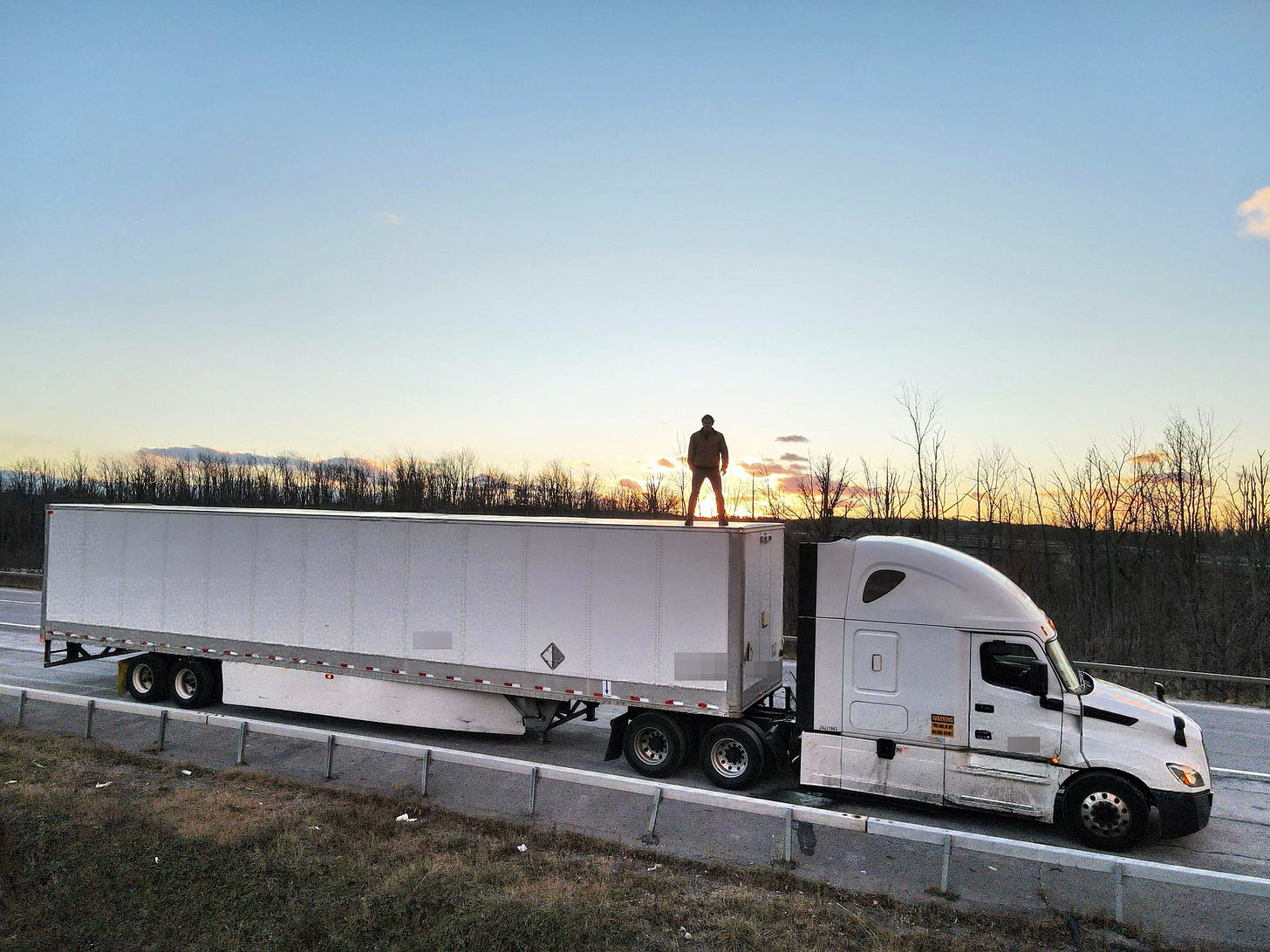 Man standing on semi trailer Man standing on semi trailer
