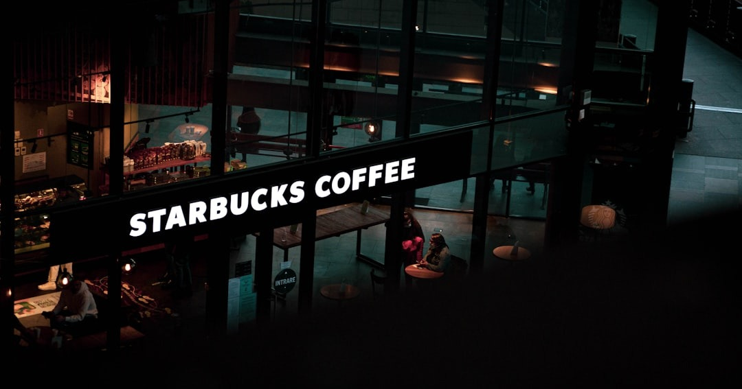 a starbucks sign hanging from the side of a building