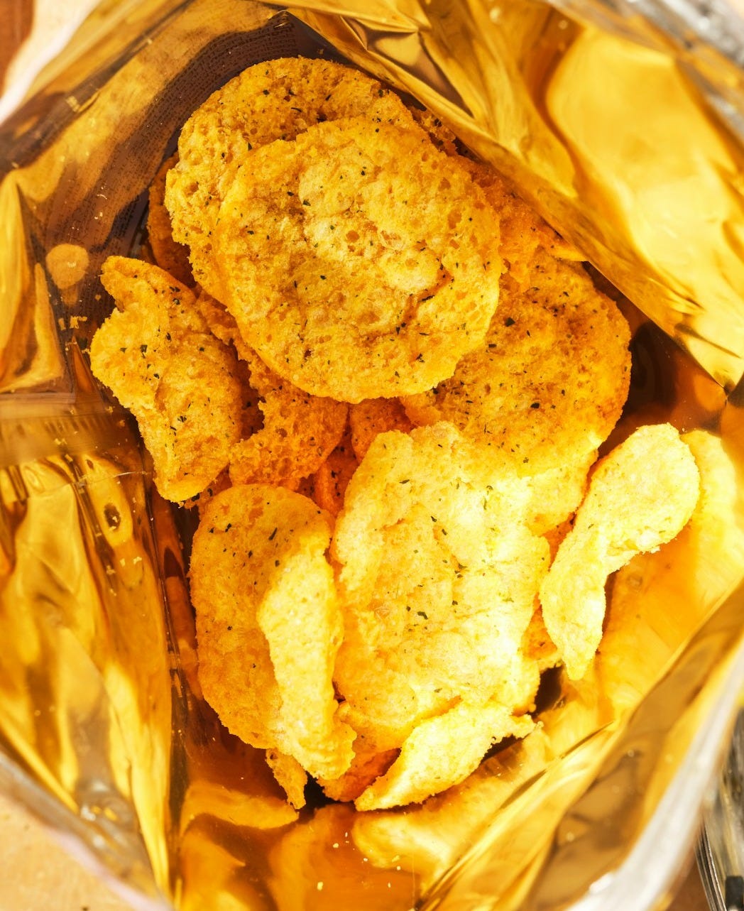 Crispy potato chips inside a golden bag