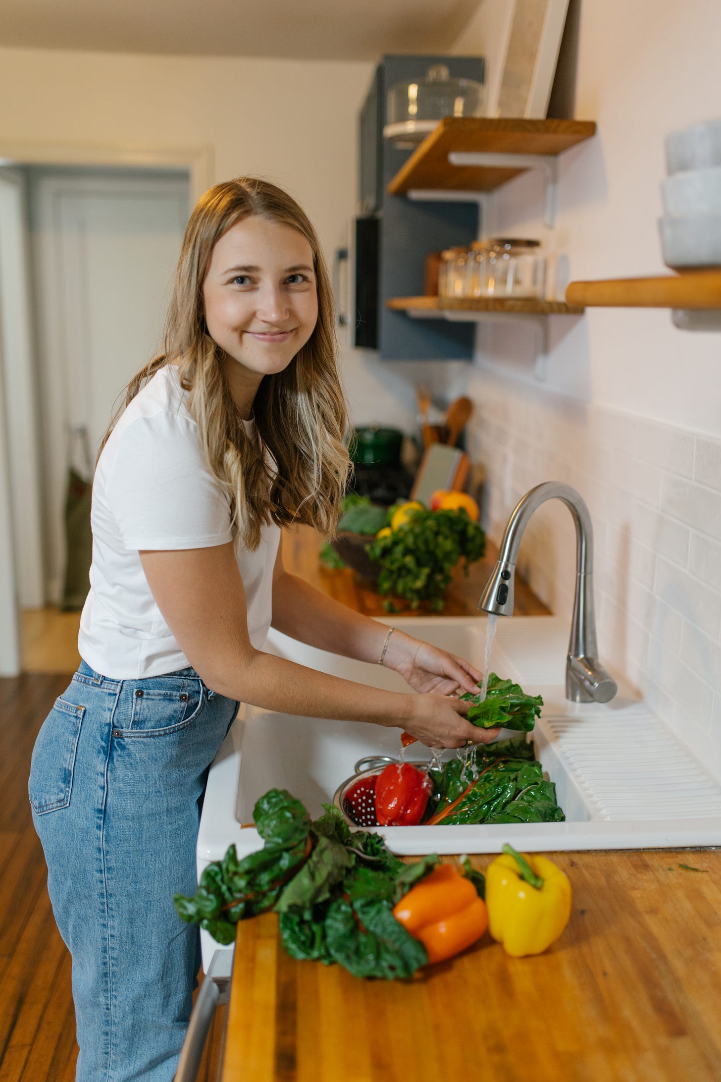 girl in the kitchen preparing veggies for a healthy, more balanced plate