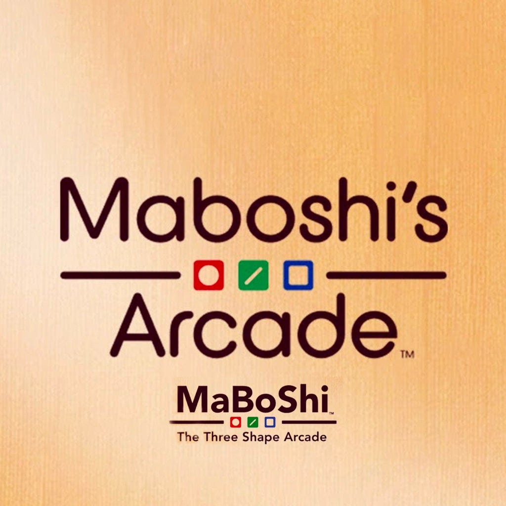 The image uses both titles of the game (Maboshi's Arcade as well as Maboshi: The Three Shape Arcade, set on the same wood-style background, with the three game "shapes" of circle, stick, and square in a row for both.