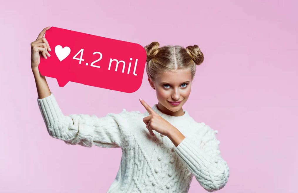 a woman holding a sign that says "4.2 million likes"