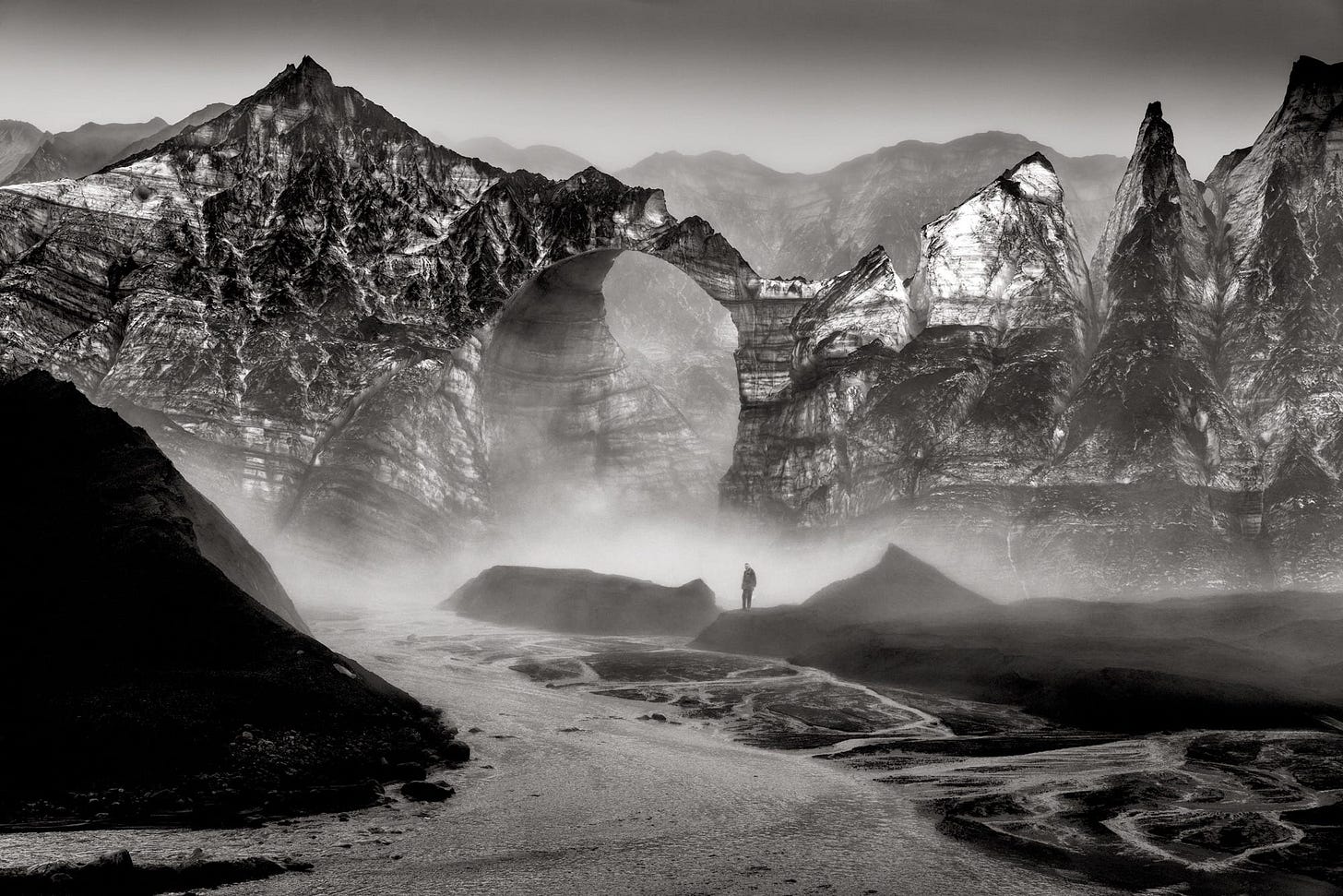 a black and white photo by Ragnar Axelsson of a person standing in a steamy landscape a black and white photo by Ragnar Axelsson of a person standing in a steamy landscape