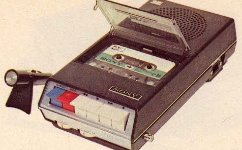 An early cassette player/recorder with a very cheap mic attached.