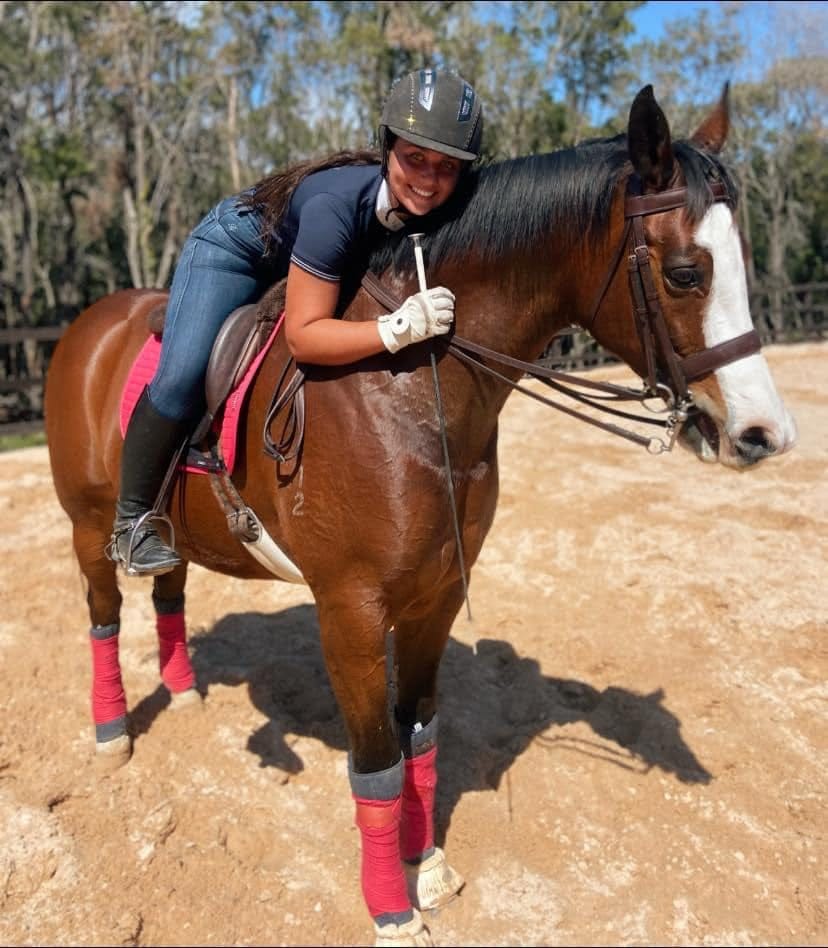 May be an image of 1 person, standing, horse and outdoors May be an image of 1 person, standing, horse and outdoors