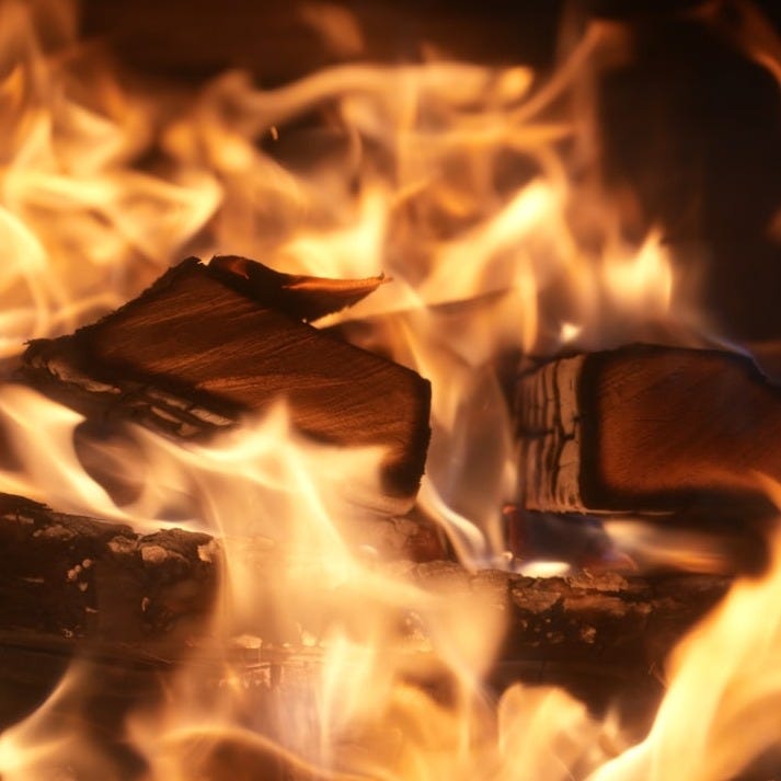 a close up of a fire burning in a fireplace a close up of a fire burning in a fireplace