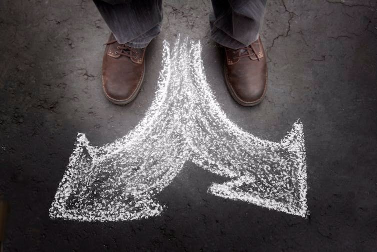 Image of a person showing arrows pointing in opposite directions the person might take. Image of a person showing arrows pointing in opposite directions the person might take.