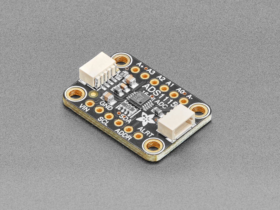 Angled shot of a black rectangular ADC breakout board. Angled shot of a black rectangular ADC breakout board.