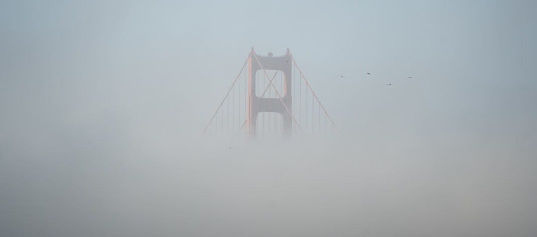 golden gate bridge covered with fog