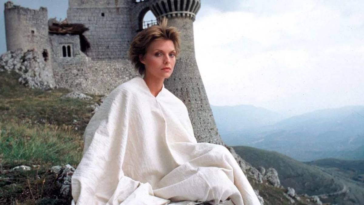 Iseabeu of Anjou sitting on the grass with a castle in the background in Ladyhawke Iseabeu of Anjou sitting on the grass with a castle in the background in Ladyhawke