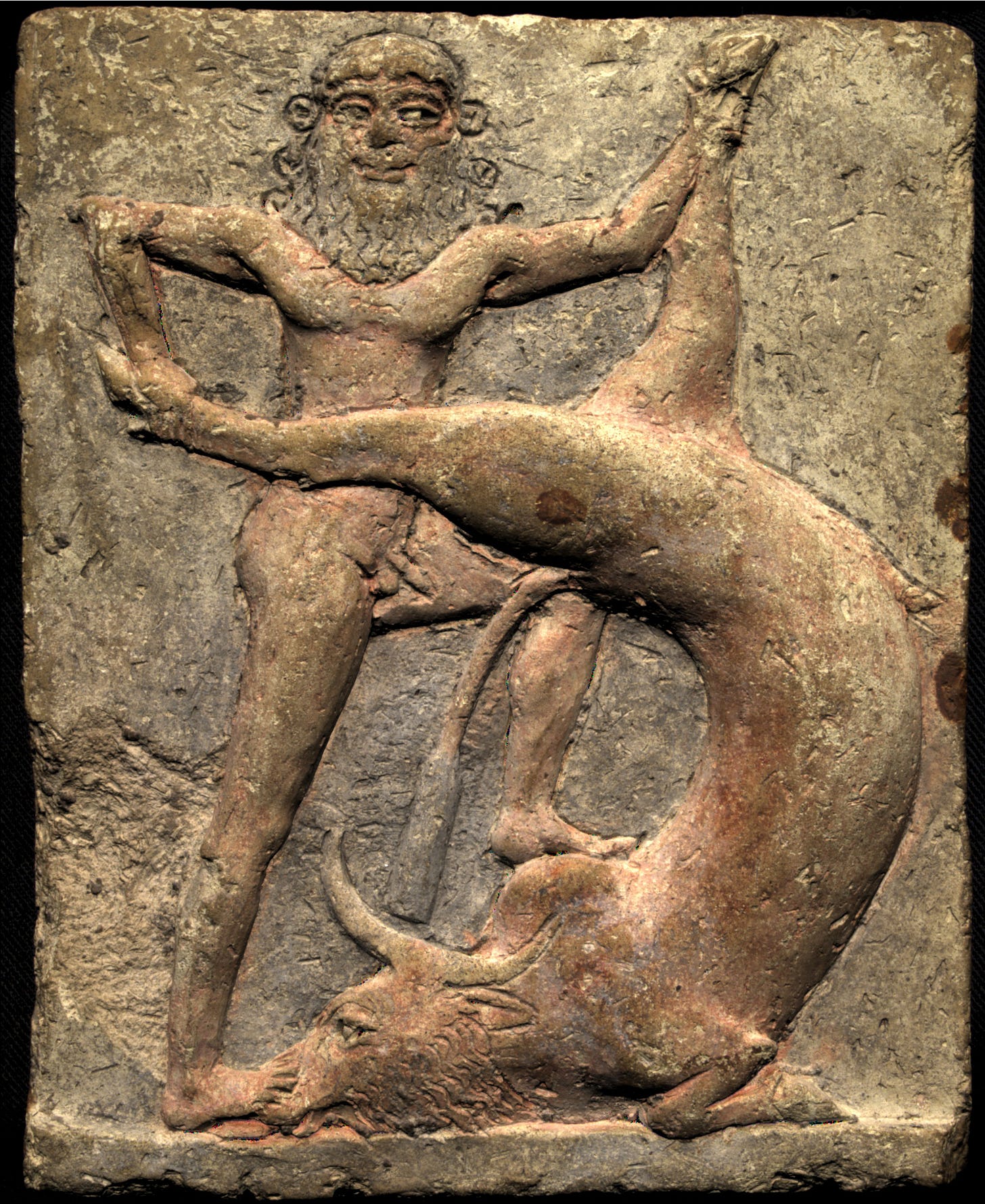 An image set in stone, of Gilgamesh defeating the Bull of Heaven.