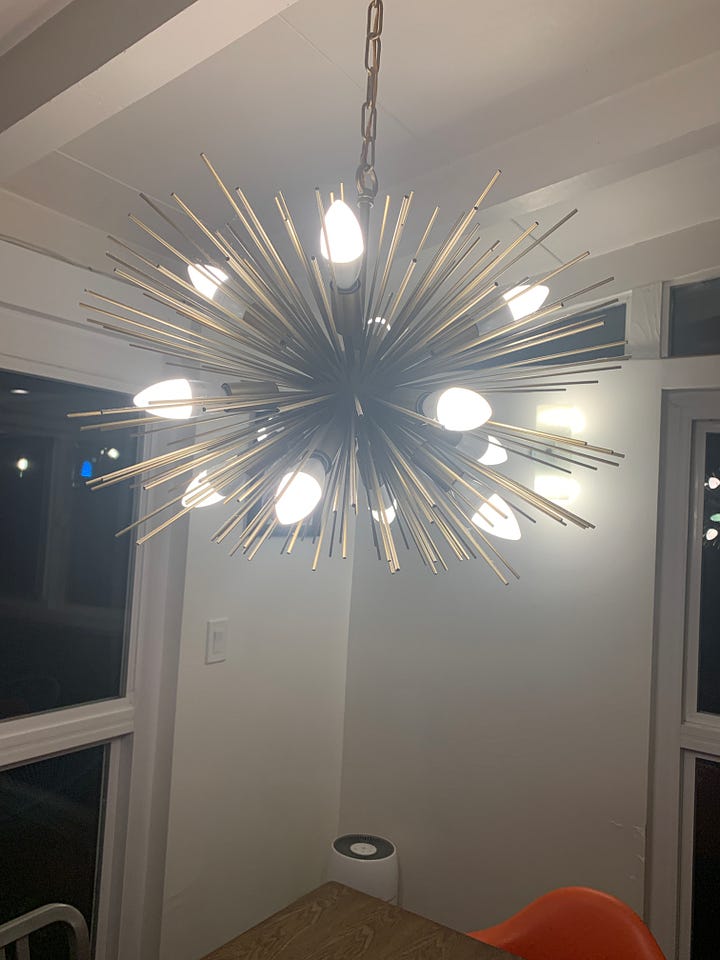 Caissie’s Sputnik chandelier with white bulbs, then pink bulbs, then blue bulbs, then multicolored bulbs.