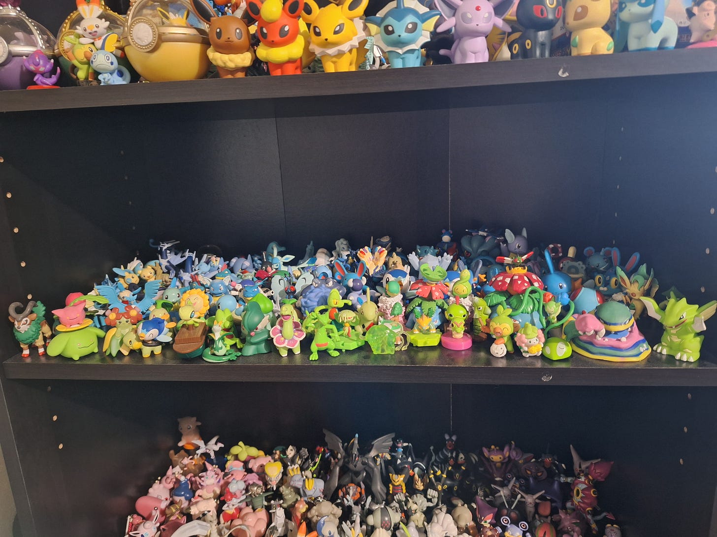 Miles has shelves upon shelves of figures, including Alolan Muk, Scyther, Articuno, Mew, Eevee evolutions, and almost any Pokémon you can think of! Miles has shelves upon shelves of figures, including Alolan Muk, Scyther, Articuno, Mew, Eevee evolutions, and almost any Pokémon you can think of!