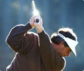 This may contain: a man swinging a golf club at a ball This may contain: a man swinging a golf club at a ball