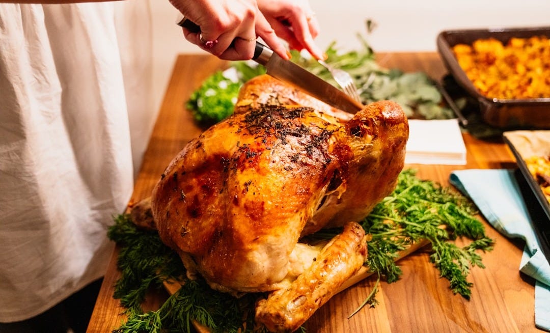 person about to slice the roasted chicken person about to slice the roasted chicken