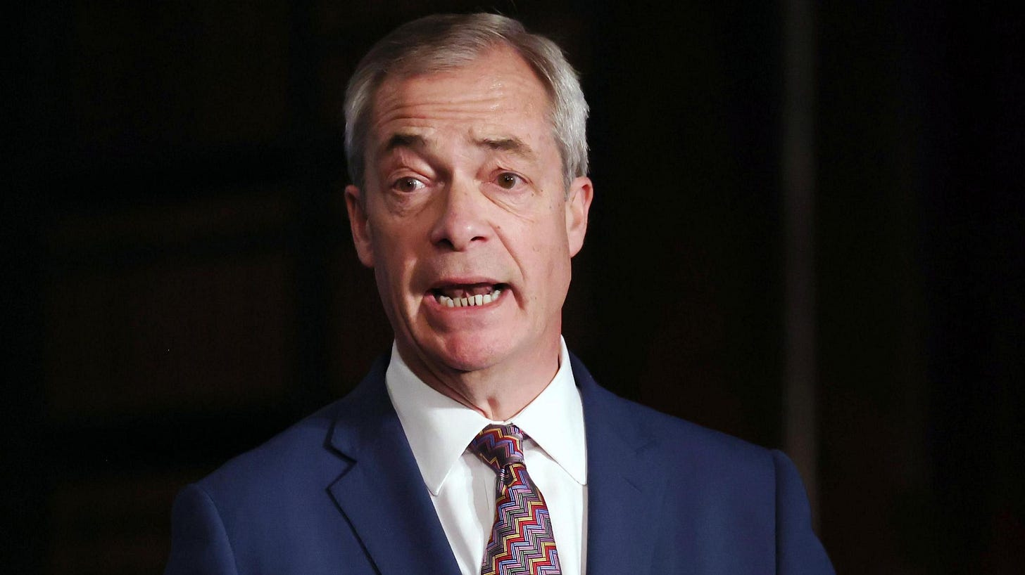 Nigel Farage dressed in a blue suit and red and blue patterned tie against a dark background