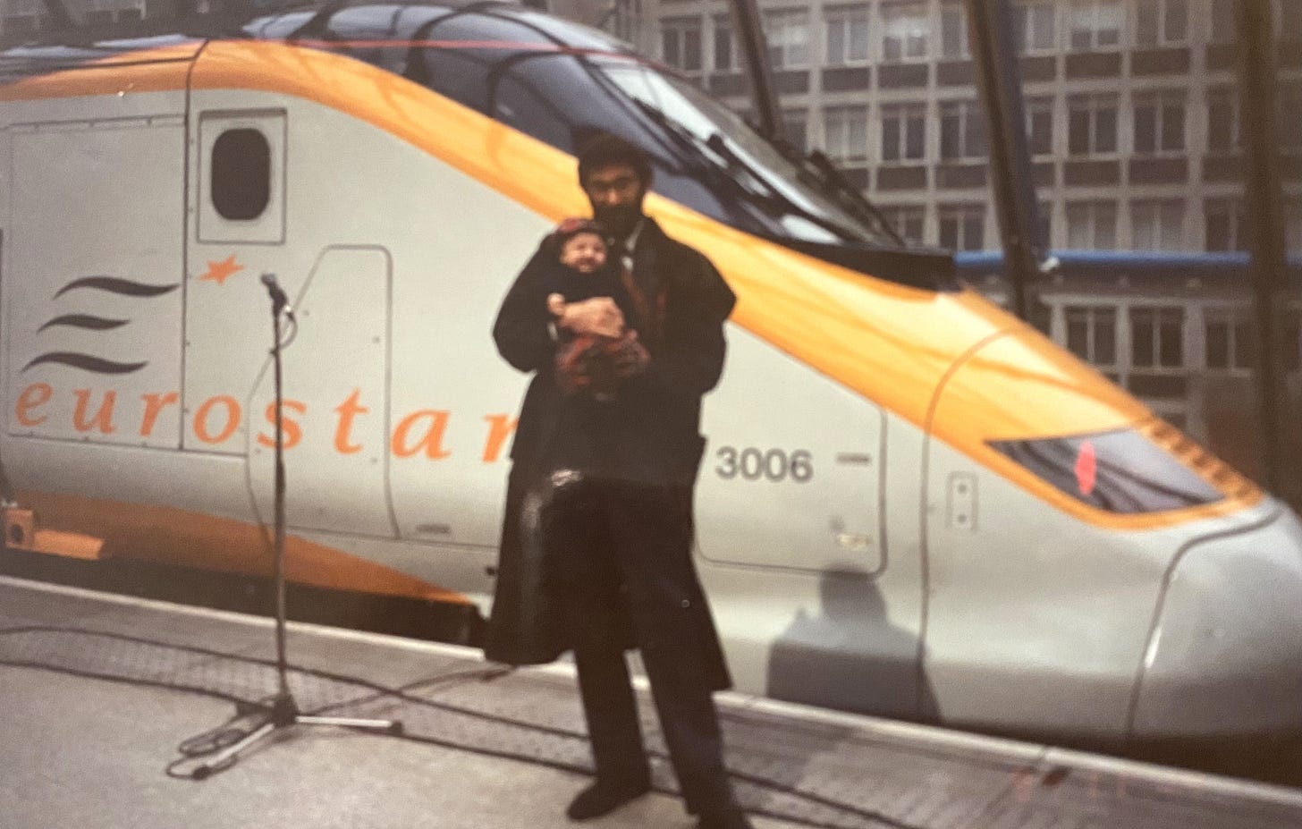 Photo of father and baby aged 3 months standing in front of the first Eurostar train to run between London and Paris