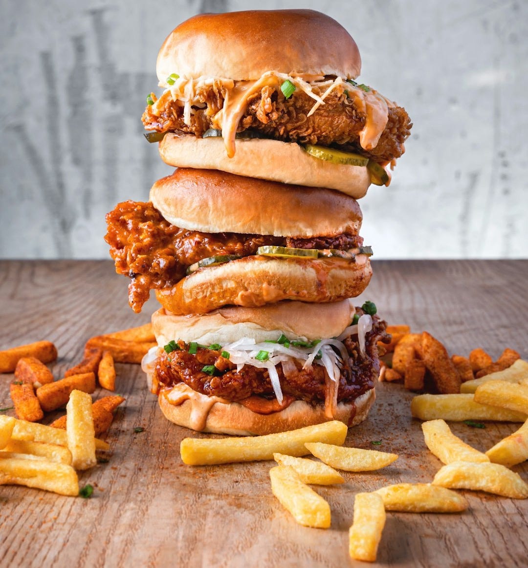 burger with lettuce and fries on brown wooden table