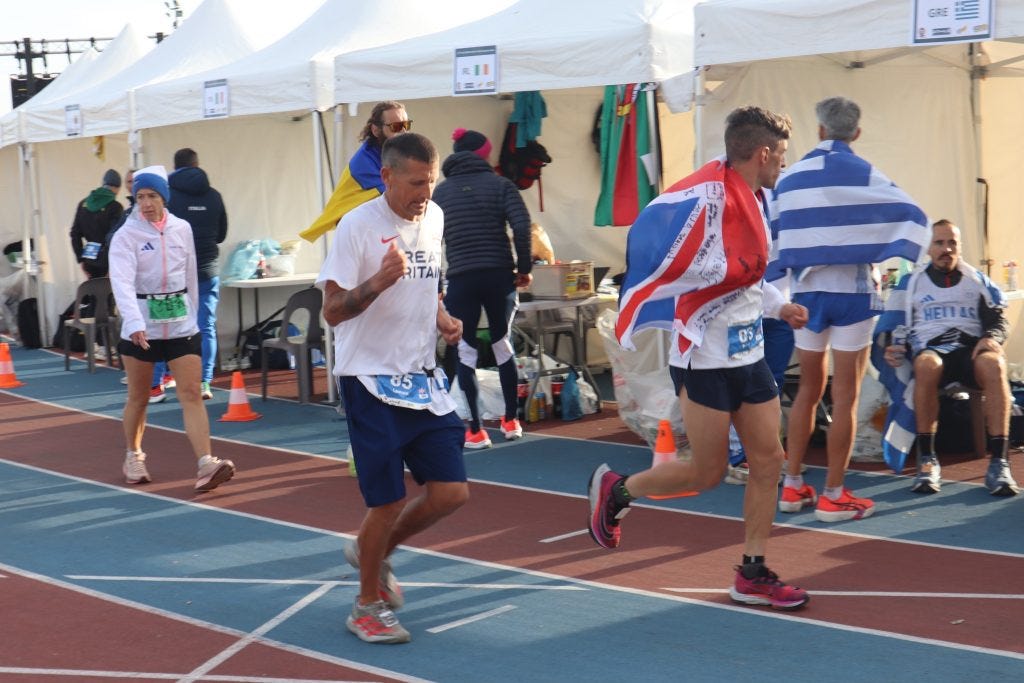 A group of people running on a track

AI-generated content may be incorrect.