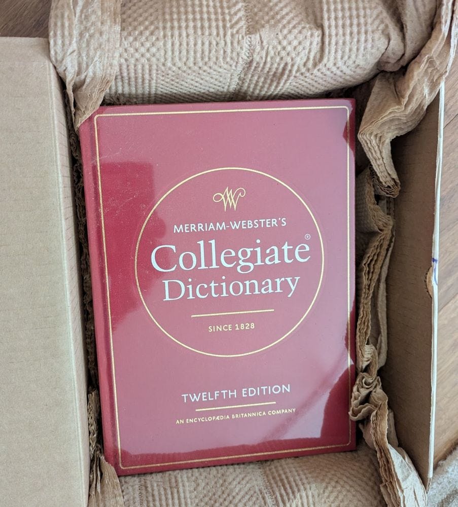 Brand new, still-in-the-box copy of Merriam-Webster's Collegiate Dictionary, 12th edition, with the traditional red cover