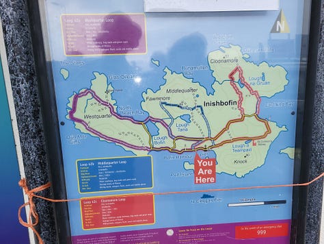 Map of Inishbofin, woman on beach, couple in boat.