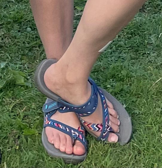 blue summer sandals being worn on grass