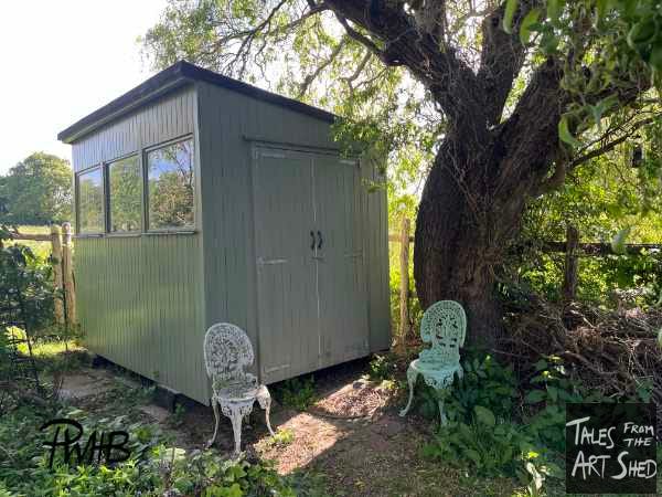 The shed painted in moss green