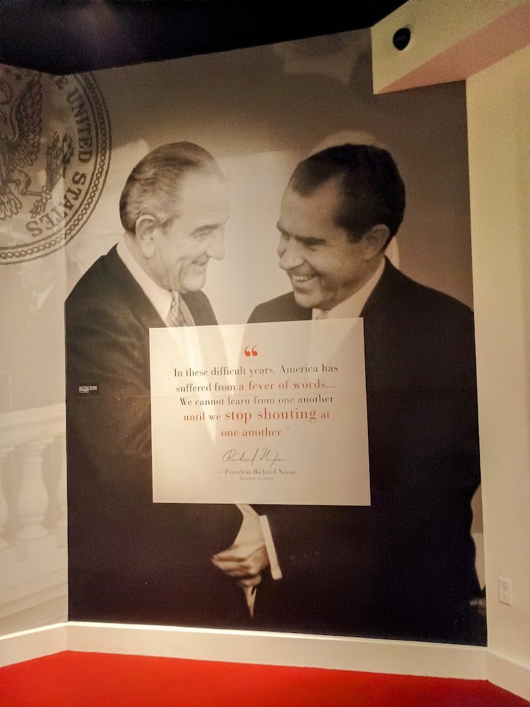 Lyndon Johnson and Richard Nixon in warm embrace, with a quote from Nixon urging Americans to stop shouting at each other