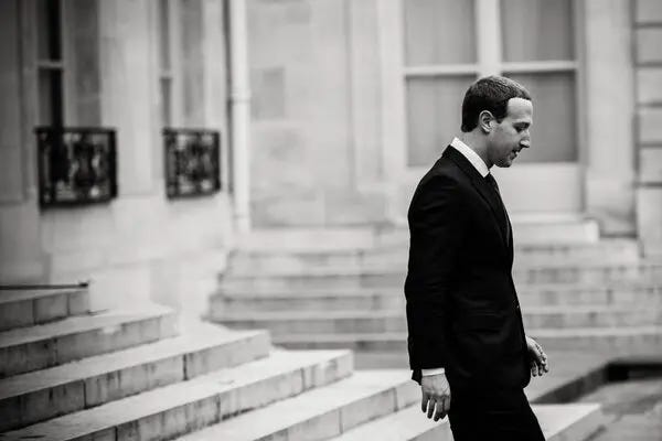 black and white photo of Mark Zuckerberg walking down a flight of stairs black and white photo of Mark Zuckerberg walking down a flight of stairs